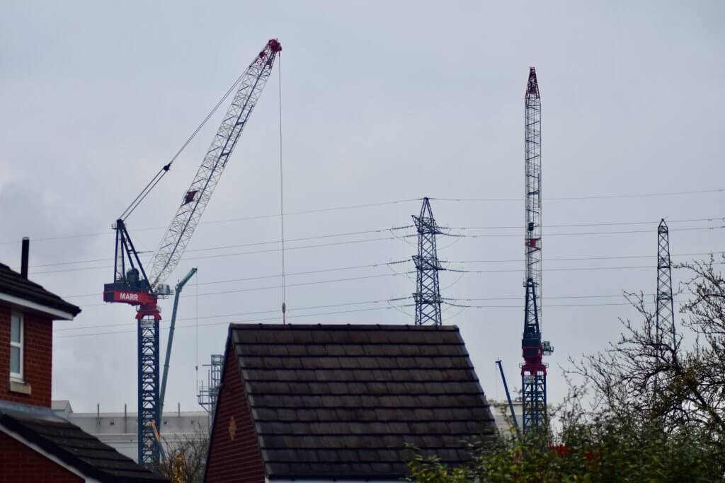 Northwich Incinerator under construction March 2024 - the twin cranes looming over the properties on Cottage Close, Rudheath